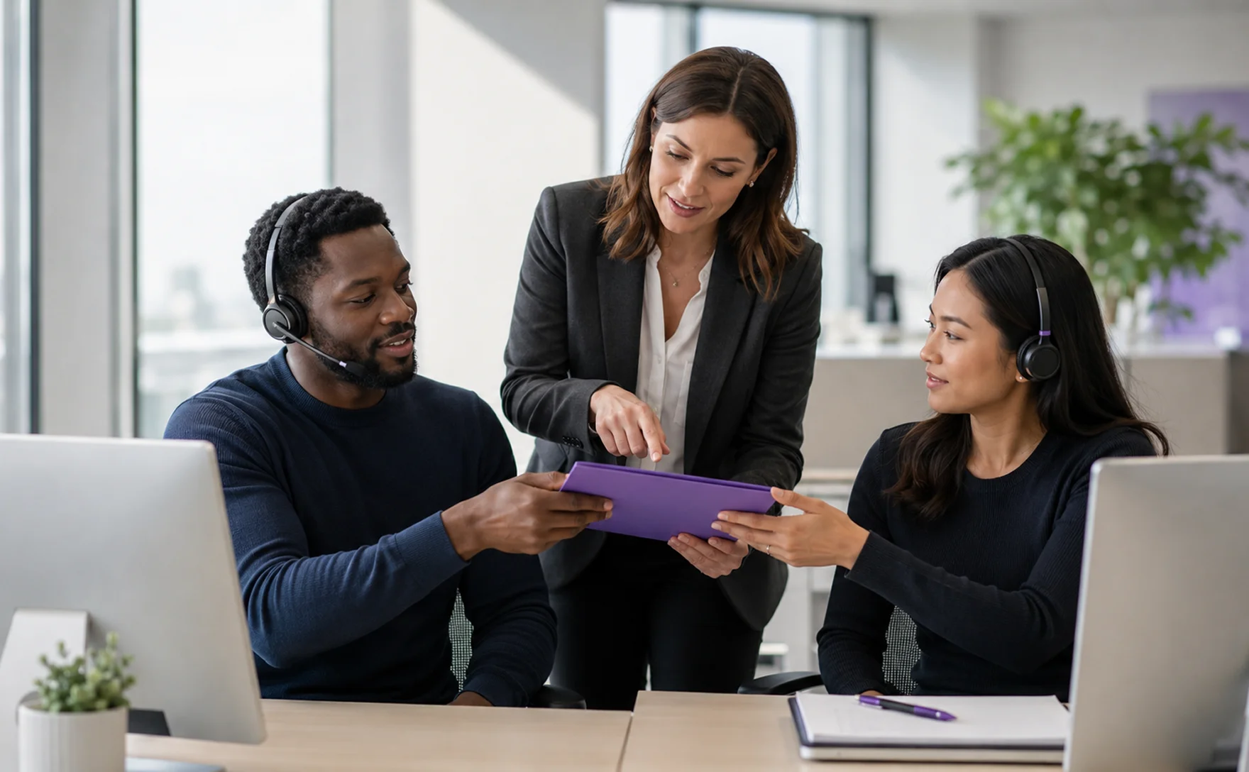 Three bank staff reviewing a case together at a laptop